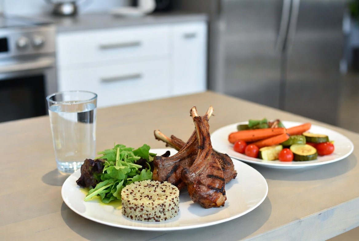 Grilled lamb chops with quinoa salad and vegetables on plate