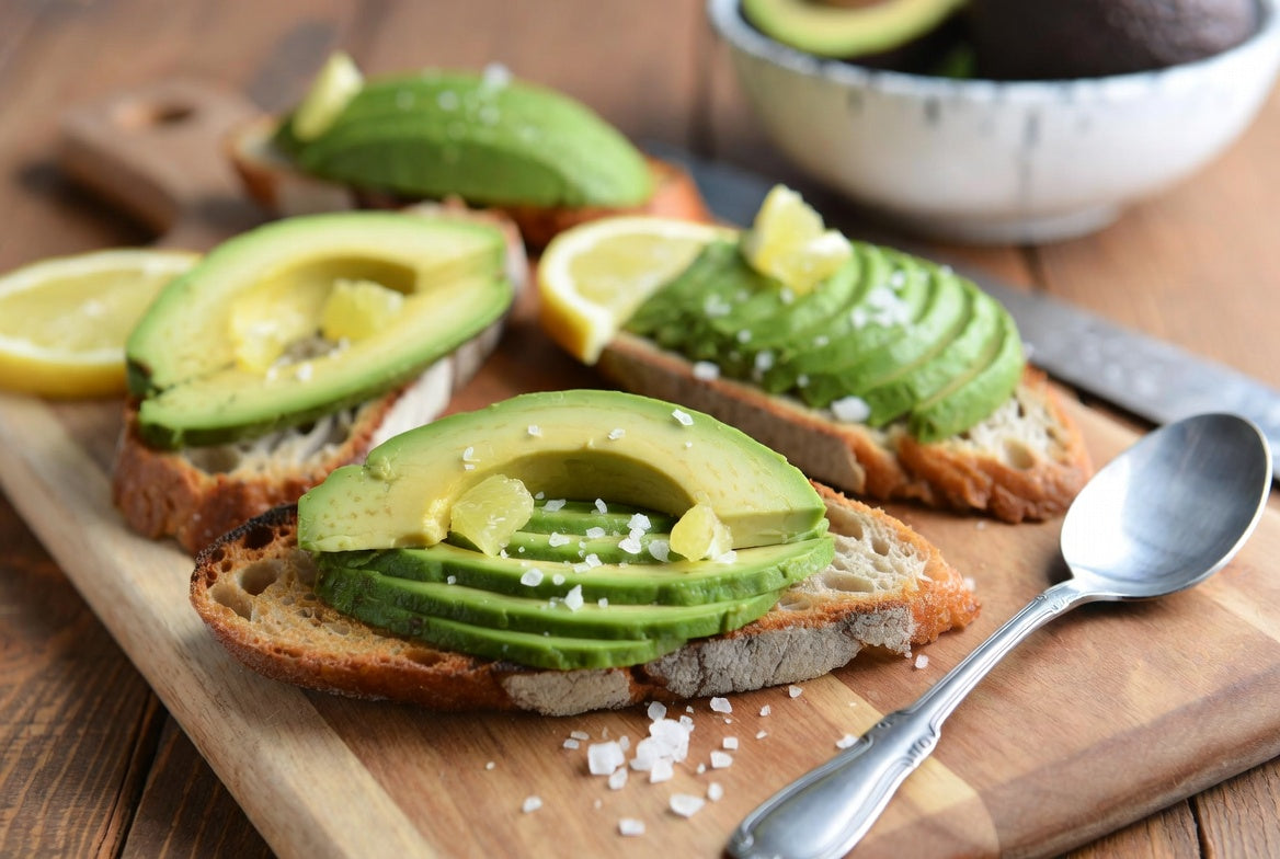 Avocado toast with lemon and salt on rustic wooden board